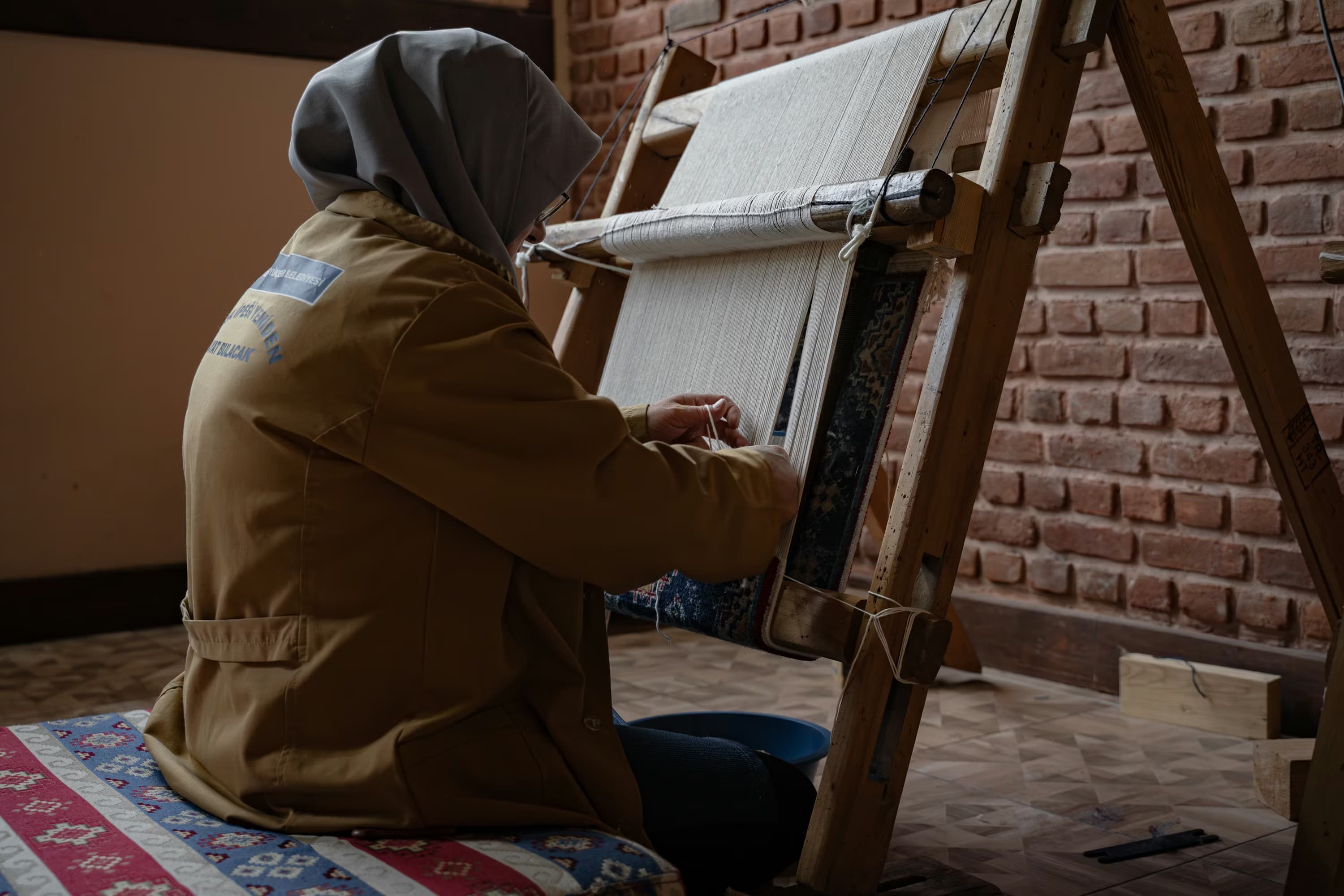 Artisan weaving at a traditional loom